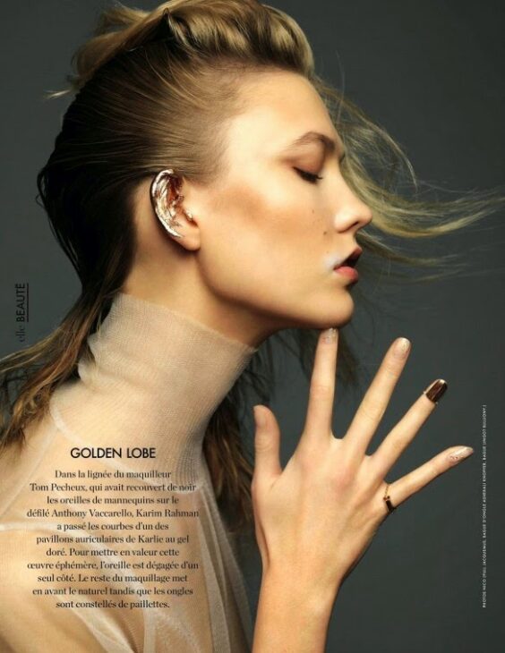 Editorial shot of Karlie Kloss with golden ear makeup.